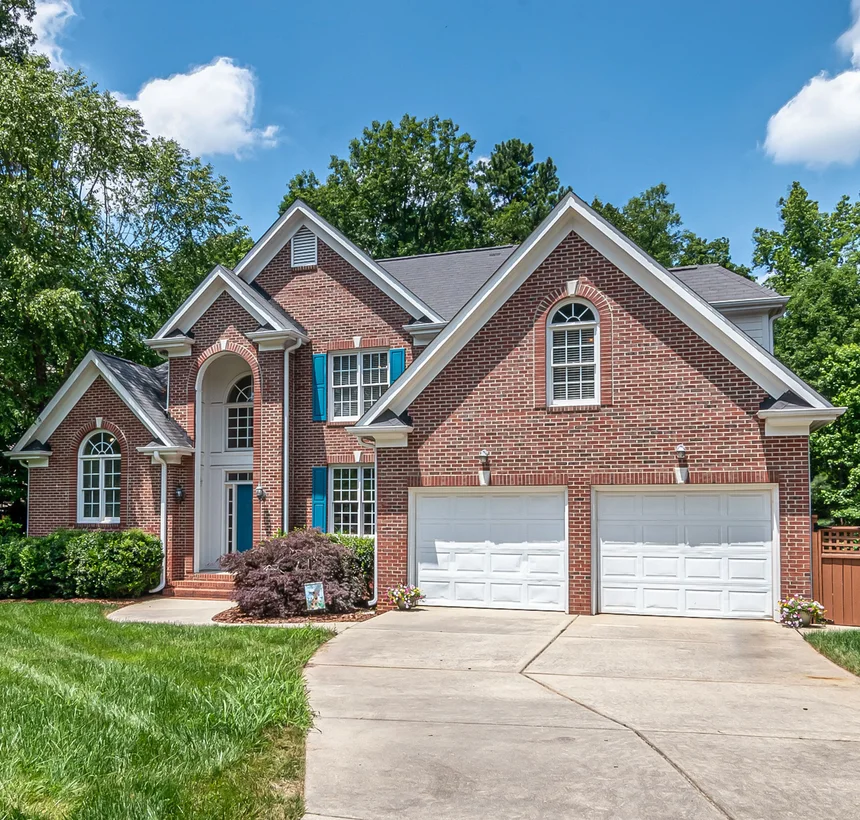 Brick colonial single-family home with a two-car garage in suburban Maryland