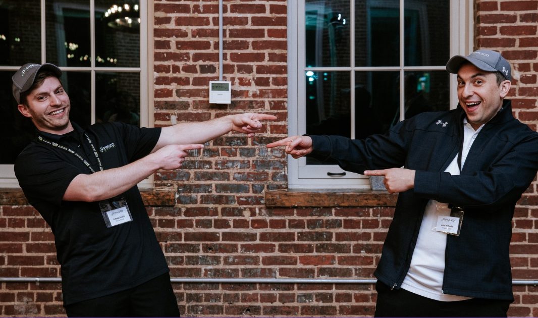 Two teammates pointing at each other